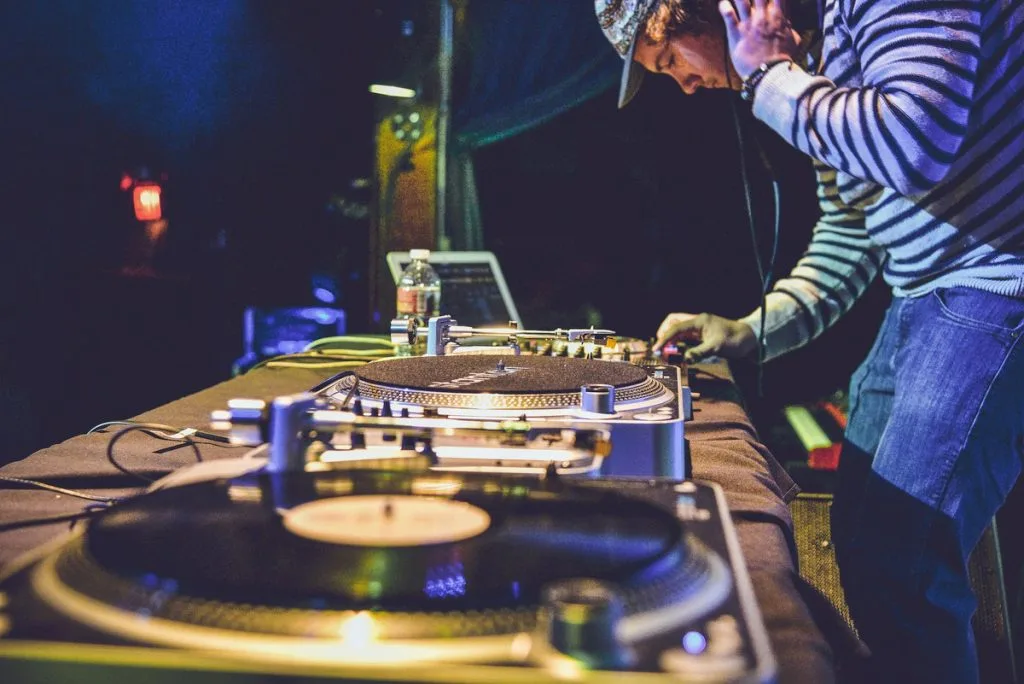 cool DJ actively mixing two songs
