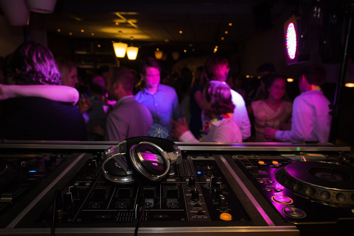dj decks and headphones dim light at party