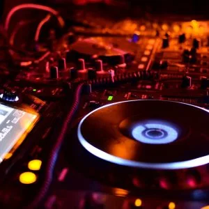 red cool light effect dj decks playing music